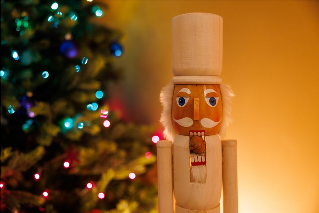 Nutcracker in front of holiday decorations