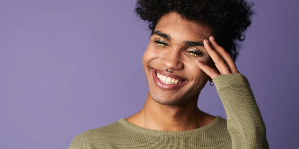Trans person of colour smiling